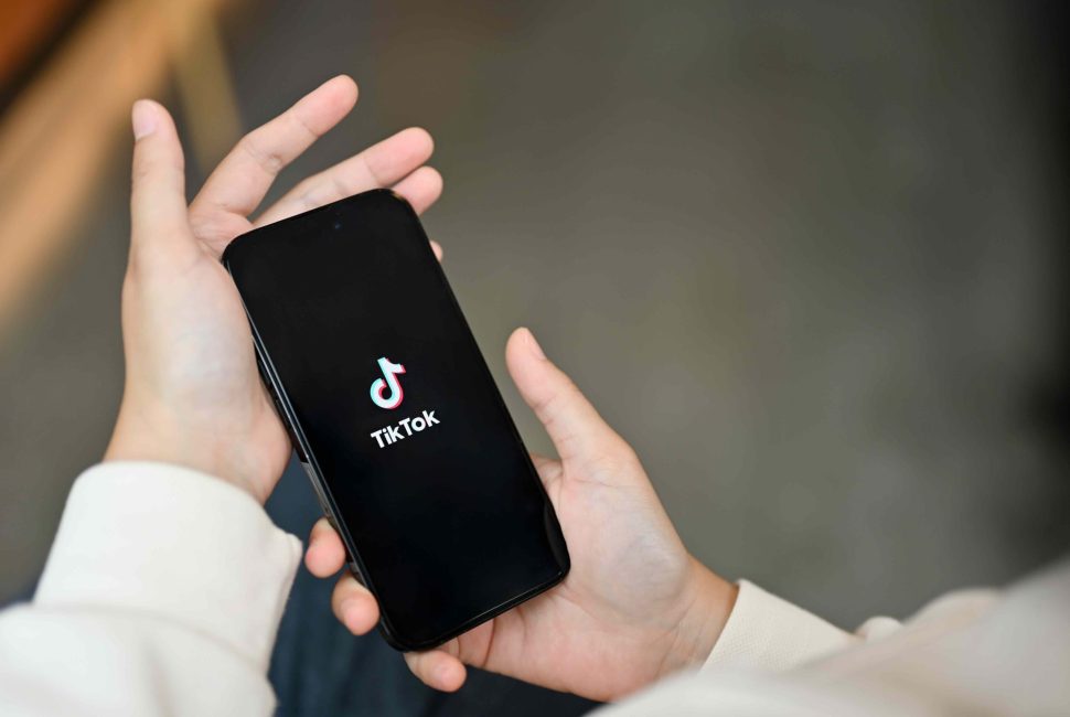 asian-woman-using-tiktok-application-her-iphone14-while-relaxing-coffee-shop_11zon