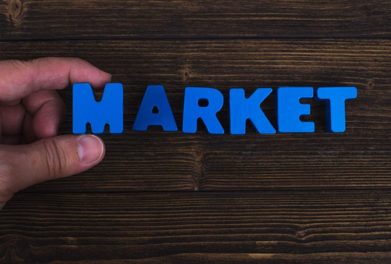 cropped-hand-person-holding-alphabet-by-text-table-min